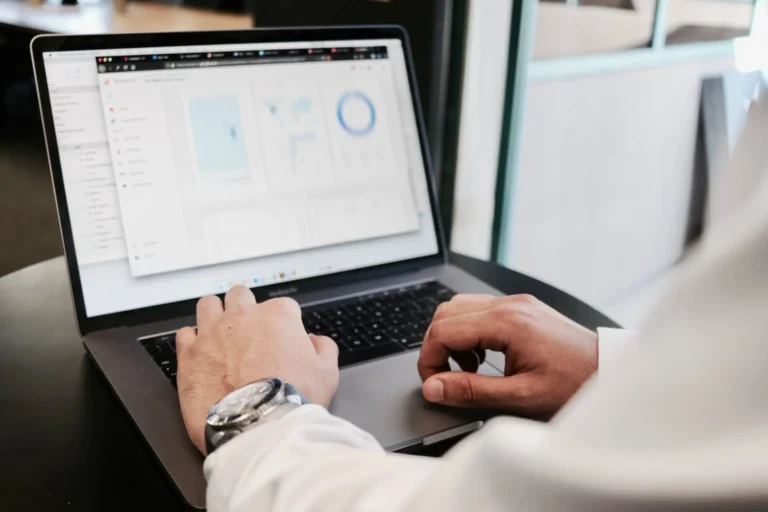EHS professional on a laptop looking at Cority Enviance Calculation Graph Visualizer