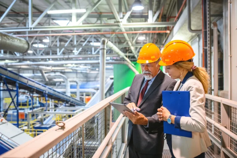 Two quality professionals discussing automated audit management