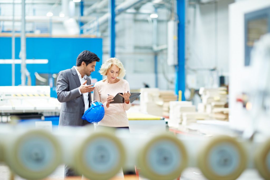 Coworkers discussing how they can improve audit management