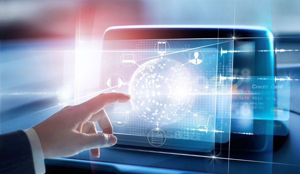 A hand interacts with a digital, tech-driven interface featuring network icons inside a car, hinting at the future of OHS.
