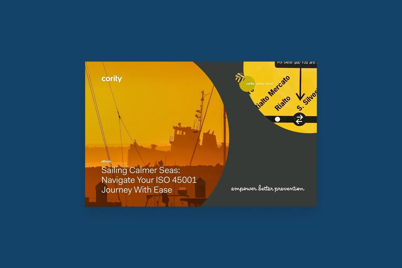 Yellow-orange cover with a ship silhouette and circular overlays, highlighting an ISO 45001 journey eBook by Cority.