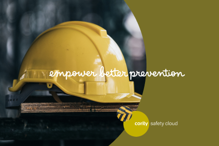 A yellow hard hat on wood, with the text empower better prevention and the Cority Safety Cloud logo, highlights safety essentials for every workplace.
