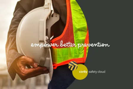 Person holding a white hard hat and wearing a safety vest, with text empower better prevention for a sustainable safety future.