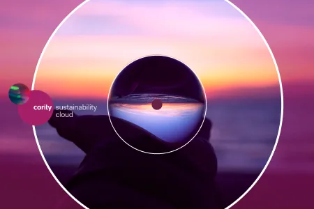 Hand holds lens at sunset with Cority sustainability cloud and CSRD Omnibus Proposal text on a vibrant purple and orange background.