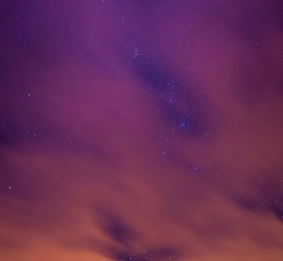 Mount Rushmore at night beneath a purple and orange sky, filled with stars and scattered clouds, stands as enduring as robust ESG Standards guiding modern governance.