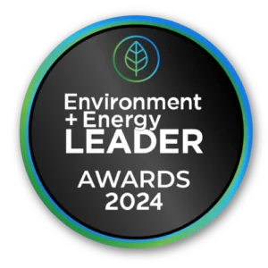 A circular badge with a green and blue border. Inside, a leaf icon is above the text “Environment + Energy LEADER AWARDS 2024” on a black background.