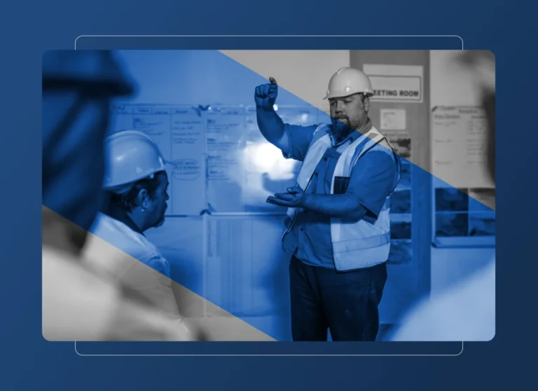 A construction worker in a hard hat and safety vest gestures while speaking to colleagues in a meeting room, discussing projects that impact the aerospace industry. The image features a blue overlay with geometric shapes and notes on whiteboards in the background.