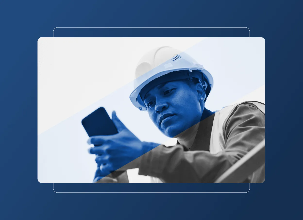 A person wearing a hard hat and safety vest, representing the construction industry, looks at a smartphone with focus. The image features a blue color overlay and graphic design elements in the background.