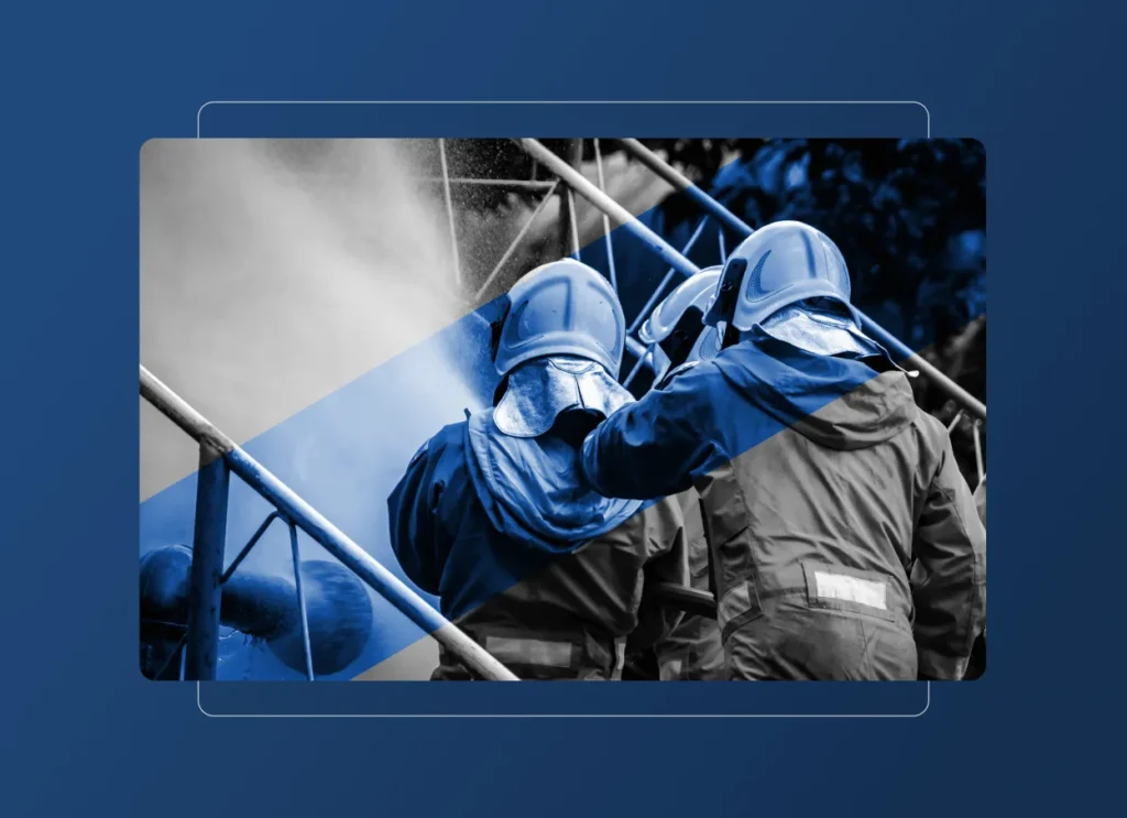Two firefighters in protective gear and helmets spray water from a hose, battling a fire. Blue graphic overlays and a dark blue background emphasize teamwork, emergency response, and their vital role in the Energy Industry.