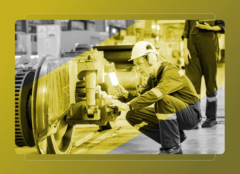 A worker wearing Safety Cloud gear inspects a train wheel assembly with a flashlight in an industrial setting, while another person stands nearby. The image features a yellow overlay for added emphasis.