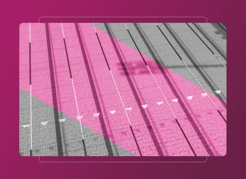 Overhead view of an empty indoor swimming pool with lane dividers and flags, mostly in grayscale, except for a large pink diagonal overlay across the pool. A subtle Sustainability Cloud effect enhances the pink gradient background surrounding the image.