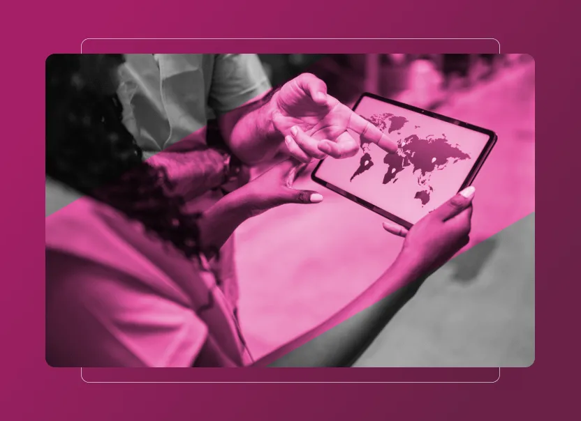Two people hold and point at a tablet displaying a world map, highlighting Sustainability Cloud insights. The image features a pink overlay and blurred background, focusing on the tablet and their hands.
