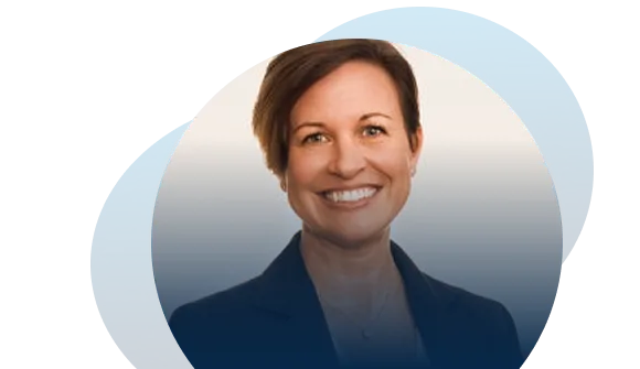 A woman with short brown hair, wearing a dark blazer and a necklace, smiles at the camera. The background features overlapping blue and white circular shapes, hinting at an innovative AI EHS environment.