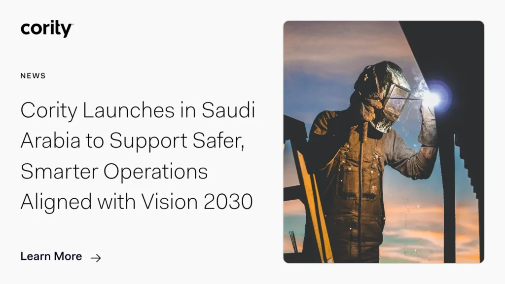 A worker in protective gear and helmet stands on a platform at sunset. Text beside reads: Cority EHS Software Launches in Saudi Arabia to Support Safer, Smarter Operations Aligned with Vision 2030. Learn More.